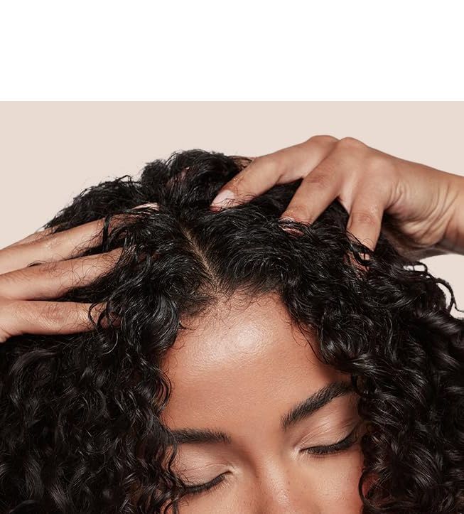 Hands massaging a curly scalp