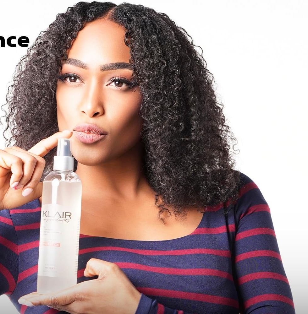 Woman holding the AKLAIR Primer spray