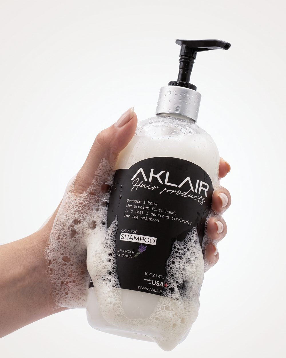 Foaming AKLAIR Biotin Shampoo in hand